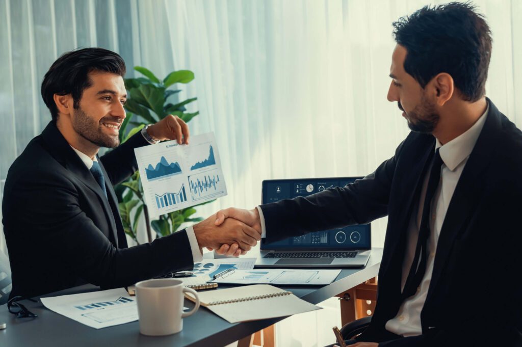 two men shaking hands with chart company s financial services 1